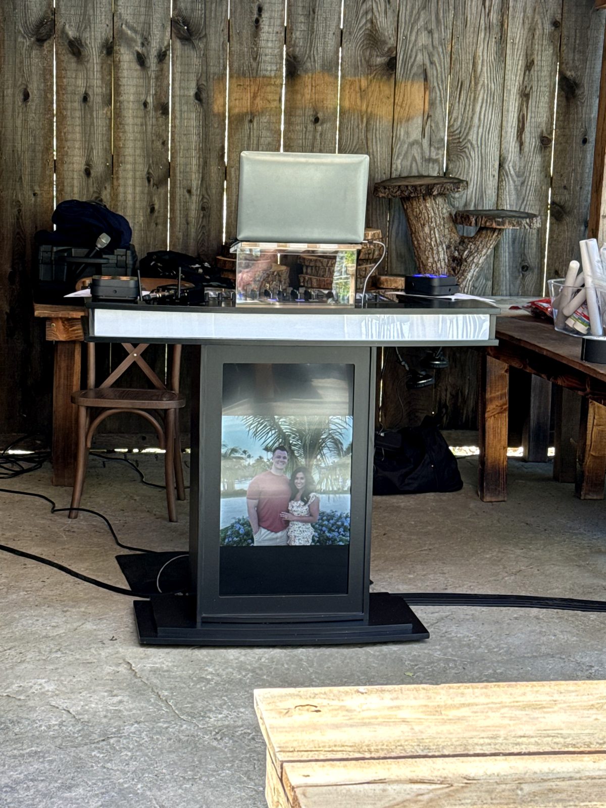 DJ Diddy booth with a couple's engagement photo on the display